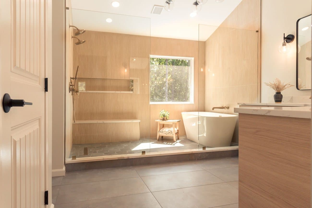 Modern basement bathroom with a tile shower and freestanding tub