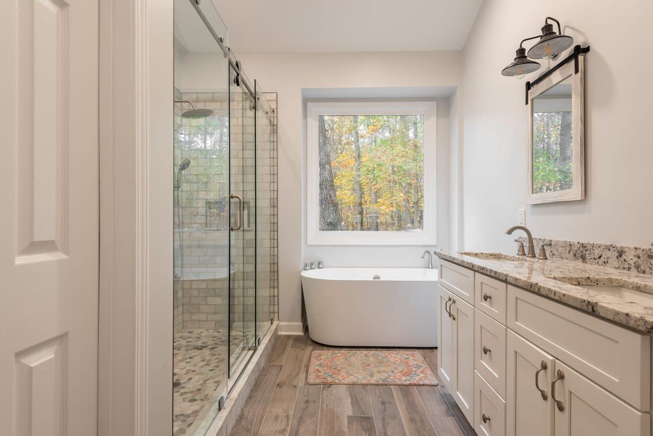 Basement bathroom with a glass shower and double vanity